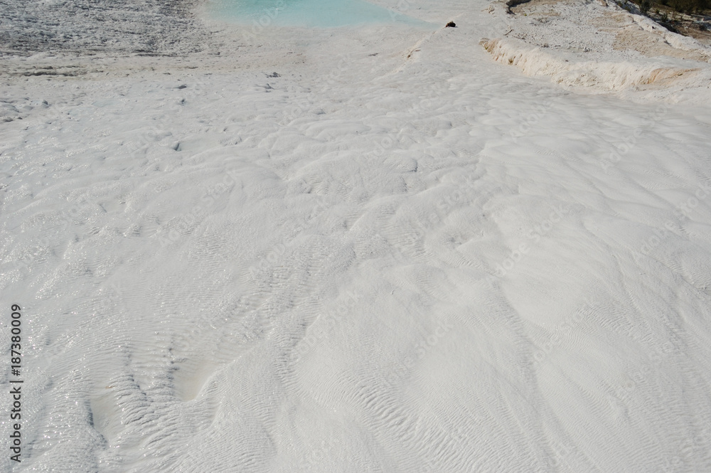 Deposits of travertine in Pamukkale, Turkey. Travertine — tufa, polycrystalline fragile grained homogeneous rock, formed by the minerals calcium carbonate, lime carbonate sediment sources, hot spring Deposits of travertine in Pamukkale, Turkey. Travertine — tufa, polycrystalline fragile grained homogeneous rock, formed by the minerals calcium carbonate, lime carbonate sediment sources, hot spring
