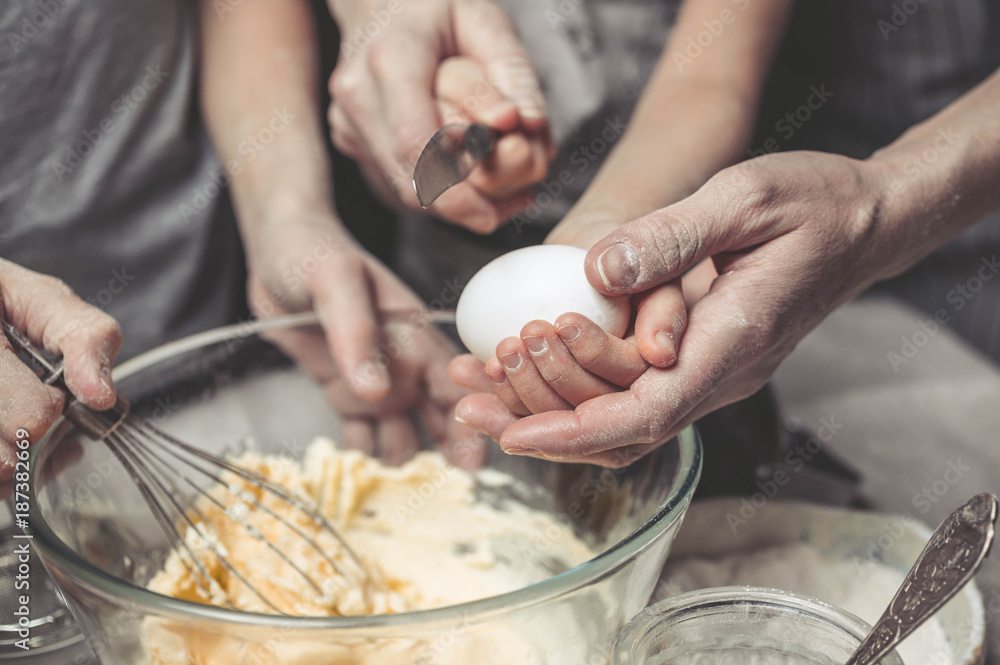 Mothers and children's hands cook dough for home-made cookies. We cook in kitchen together with children. Happy family Mothers and children's hands cook dough for home-made cookies. We cook in kitchen together with children. Happy family