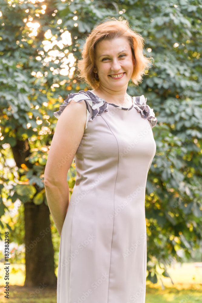 Portrait of Attractive Smiling Caucasian Ethnicity Young Woman in the park. Portrait of Attractive Smiling Caucasian Ethnicity Young Woman in the park.