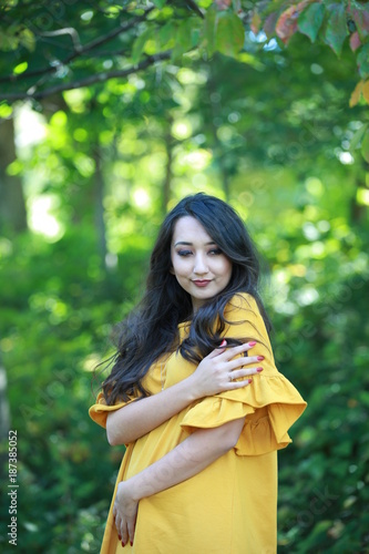 Woman in yellow dress in park