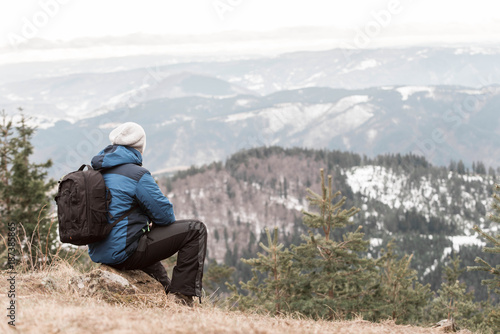 photographer from behind with backpack looking at mountains. Zlatibor, Tornik - Serbia