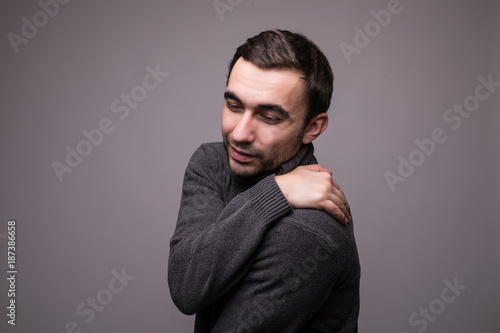 Attractive model on gray background having neck pain photo