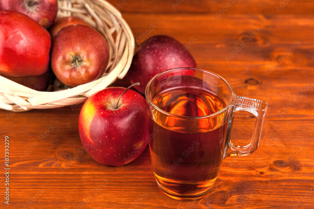 fresh red apples in wicker basket on wooden table fresh red apples in wicker basket on wooden table