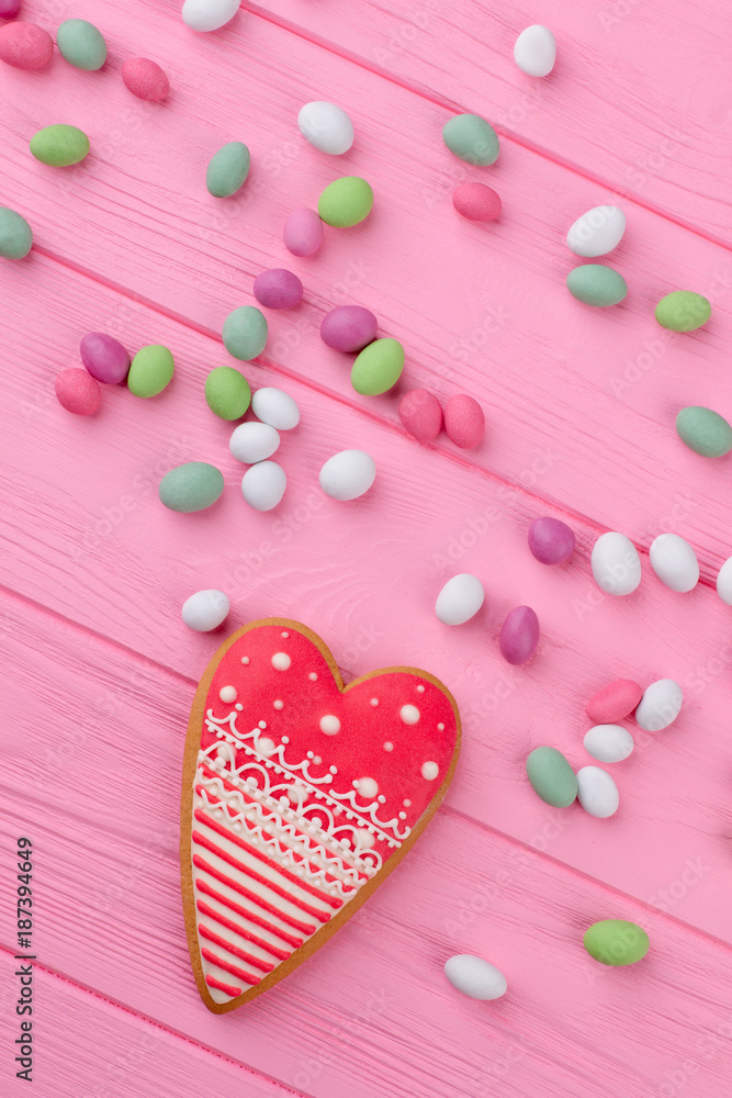 Composition with candies and cookie. Valentines Day pink wooden background with sweets, top view. Composition with candies and cookie. Valentines Day pink wooden background with sweets, top view.