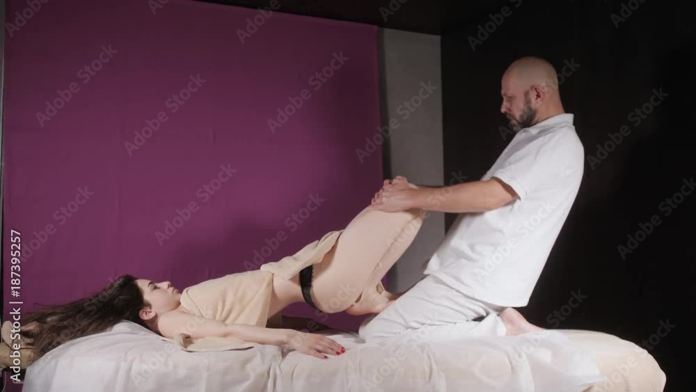 Wellness foot massage. Close up of osteopath doing manipulative massage. Man hands massaging female. Spa centre concept Wellness foot massage. Close up of osteopath doing manipulative massage. Man hands massaging female. Spa centre concept