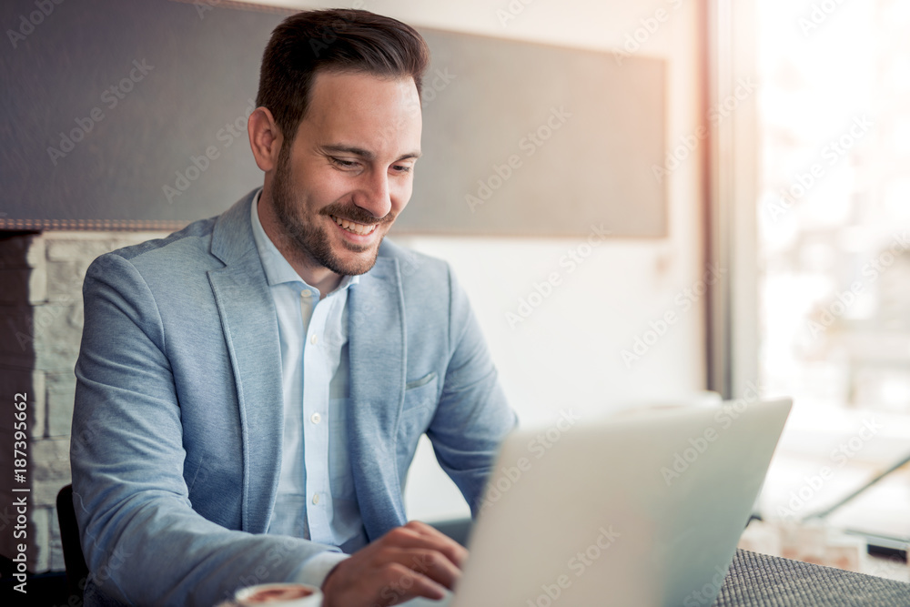 Portrait of young man sitting at his desk in the office. Portrait of young man sitting at his desk in the office.