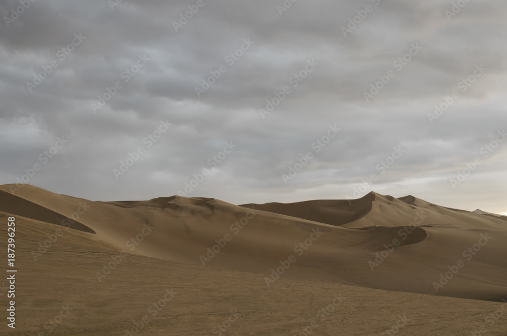 View to the sand desert under cloudy sky View to the sand desert under cloudy sky