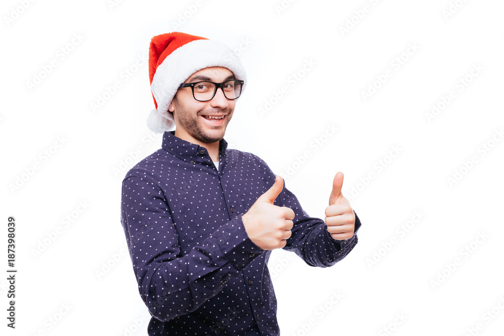 Handsome Business man wear santa hat showing thumb up on white isolated background.