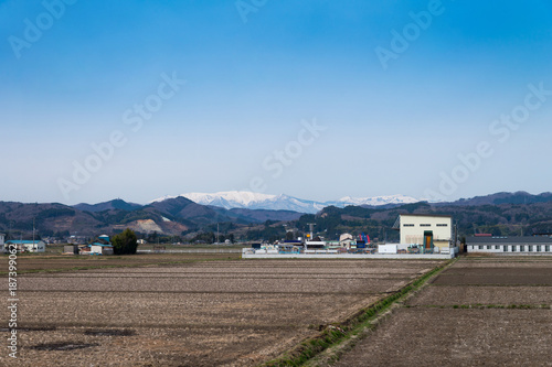 Agricultural field area and Agribusiness in the countryside, fukushima with azuma snow-capped mountains background view, japan © lukyeee_nuttawut