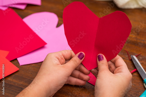 Someone holding a folded cut out heart
