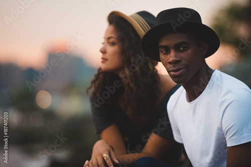 Couple sitting outside at sunset photo