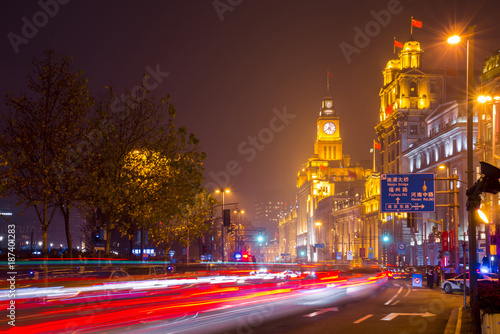 Historical architecture on the bund of Shanghai with City lights and traffic lights at night, waterfront of the Huangpu River is a popular tourist destination of Asia. Shanghai, China
