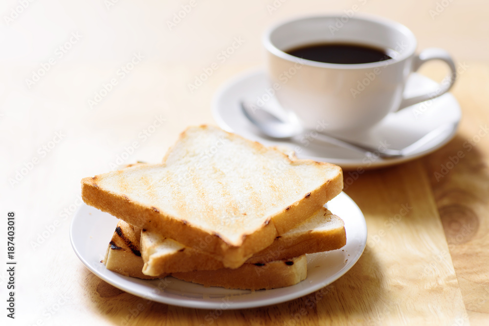 Breakfast with toast and coffee on wooden table