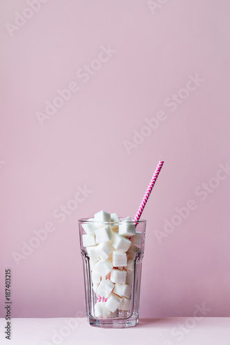Glass filled with sugar cubes photo