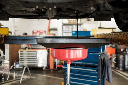 Oil dripping during oil change in his auto repair shop