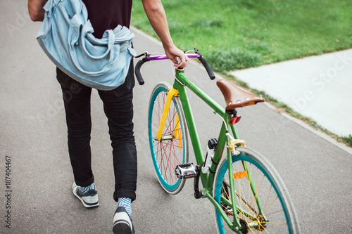 Handsome south-east asian guy with a  cool colorful  bike photo