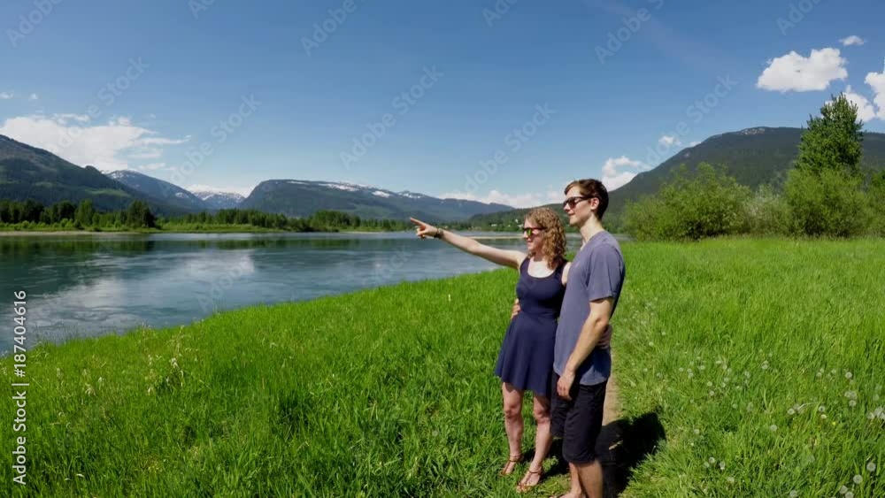 Couple pointing out at distance Couple pointing out at distance