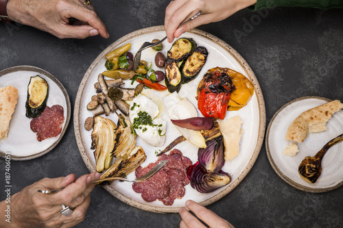 Two woman sharing an Italian appetiser plate