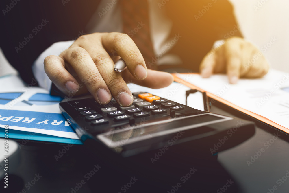 Business man accountant using calculator to calculating bugget Business man accountant using calculator to calculating bugget