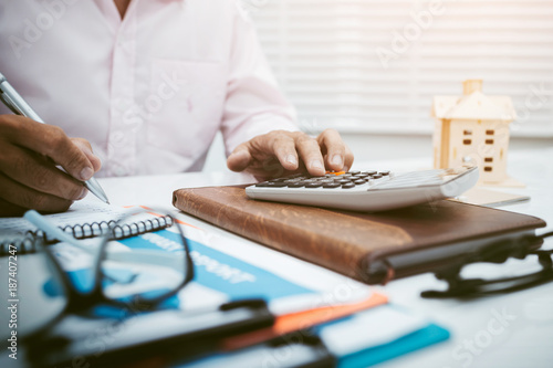 Business man accountant using calculator to calculating bugget photo