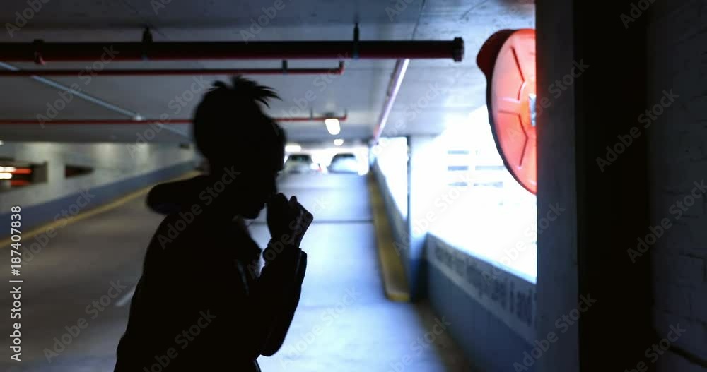 Woman practicing boxing in underground parking area Woman practicing boxing in underground parking area