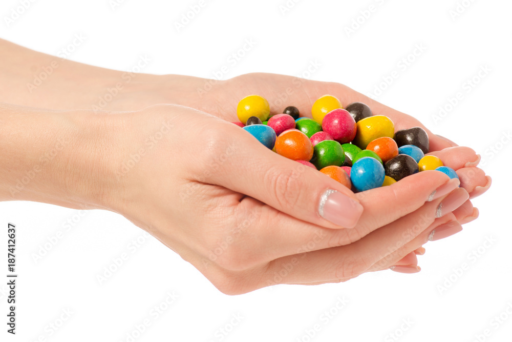 Bucket Nuts in a multi-colored glaze dragee in hand Bucket Nuts in a multi-colored glaze dragee in hand