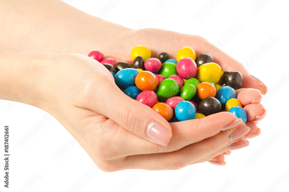 Bucket Nuts in a multi-colored glaze dragee in hand Bucket Nuts in a multi-colored glaze dragee in hand