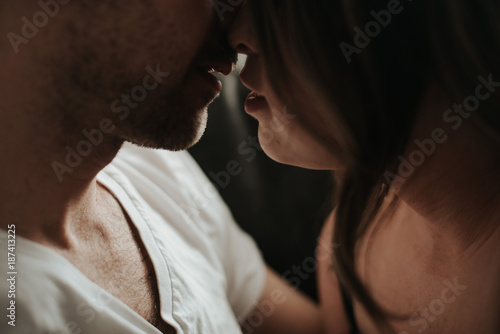 Young couple kissing in living room apartment