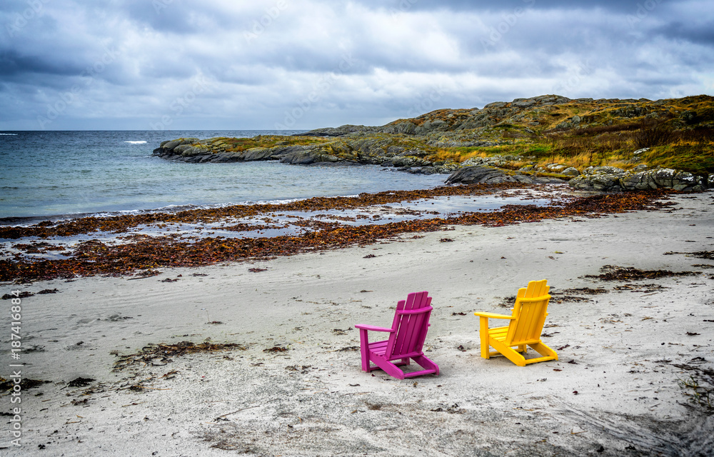 Colorful chairs at beach in Norway