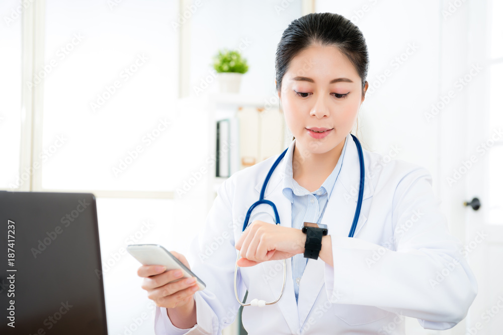 doctor looking at smartwatch confirm connection doctor looking at smartwatch confirm connection
