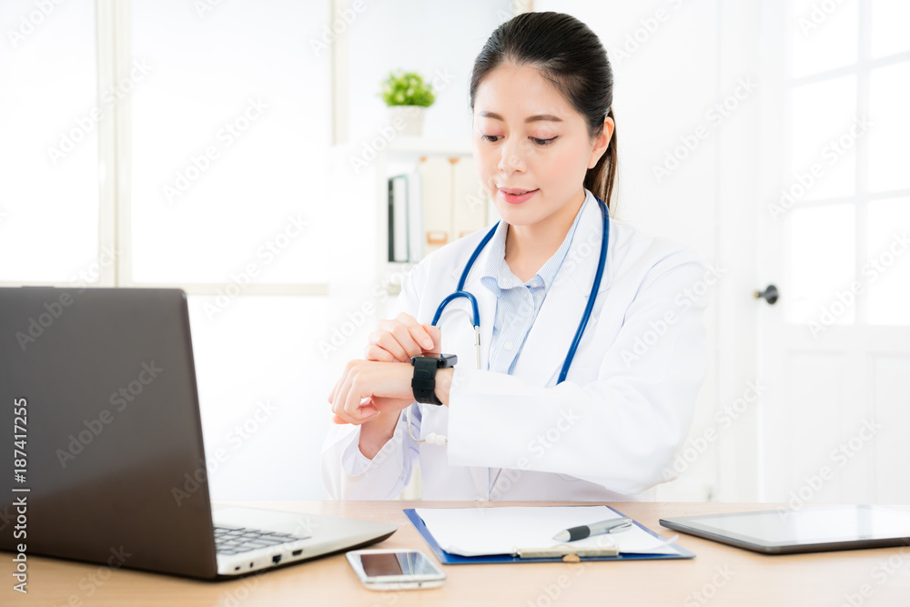 attractive happy doctor touching smartwatch screen attractive happy doctor touching smartwatch screen