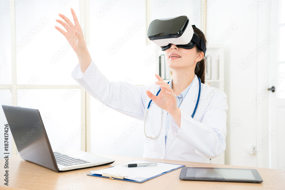 Fototapeta premium attractive pretty doctor wearing VR technology
