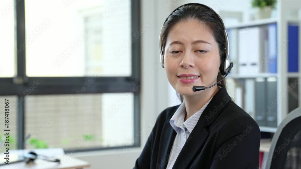 smile Asian operator working with a headset smile Asian operator working with a headset