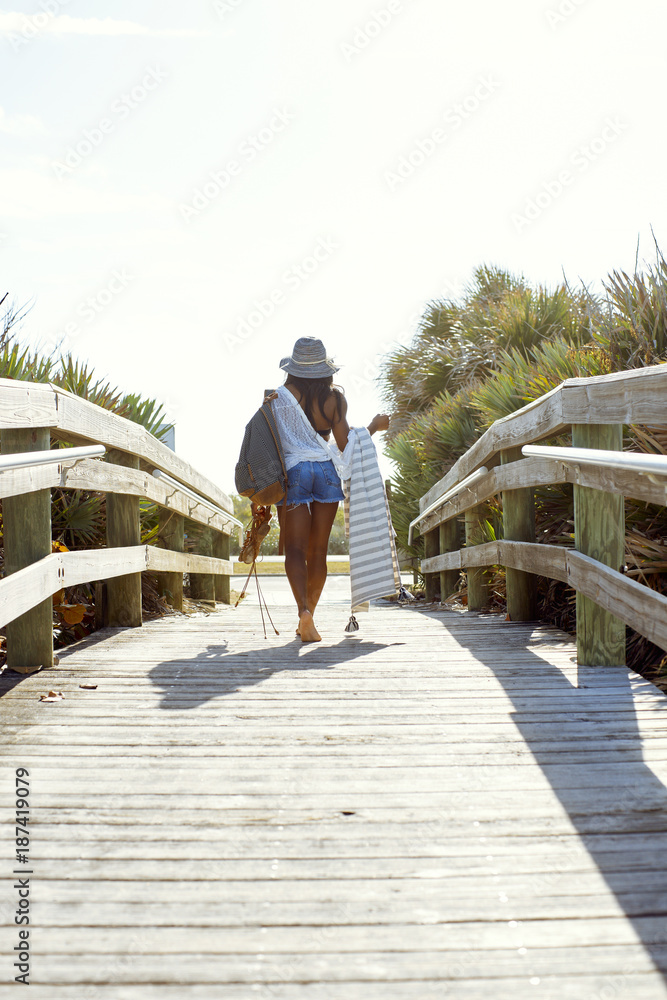 millennial woman leaves the beach millennial woman leaves the beach