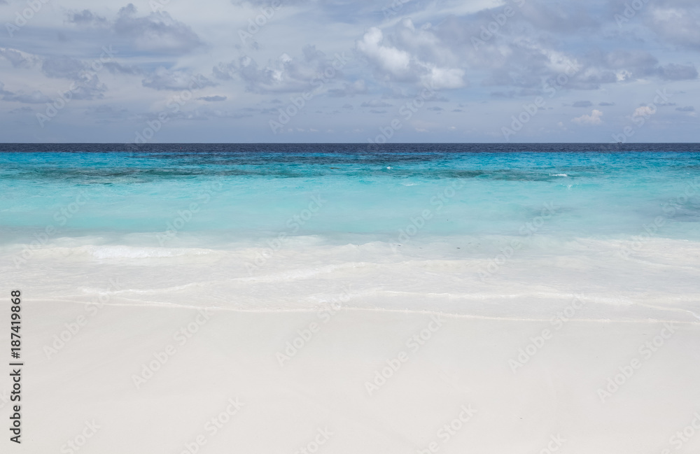 White beach sand and beautiful blue sea and sky