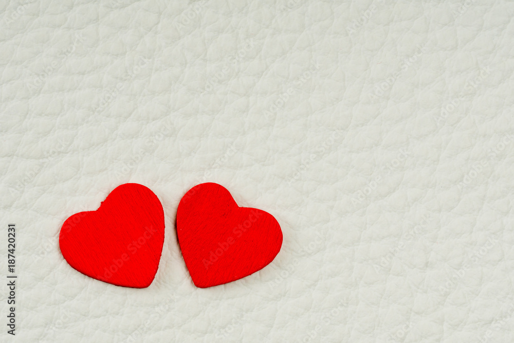 valentine's day card, two red hearts on white leather valentine's day card, two red hearts on white leather