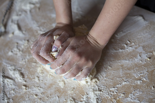 Woman hands kneading dough on the table
