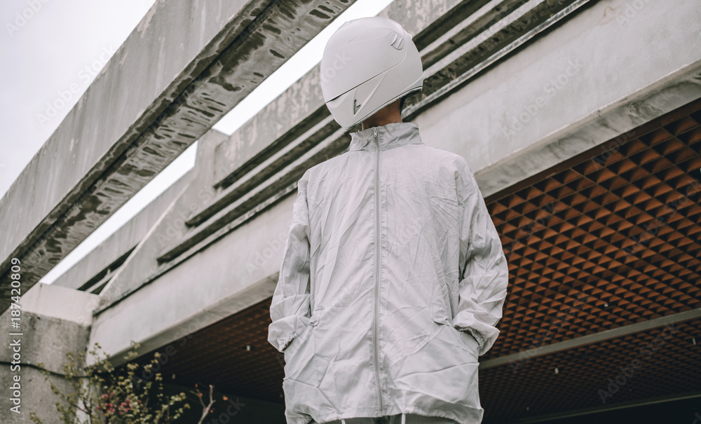 Abstract scene with person with white helmet/mask and silver jacket Abstract scene with person with white helmet/mask and silver jacket