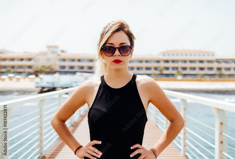 Portrait of woman with sunglasses on the pier Portrait of woman with sunglasses on the pier