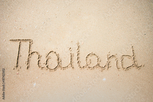 Thailand word is written on the beach sand