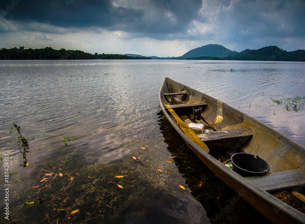 Fototapeta premium Boat Moored On Lake Against Sky During Sunset