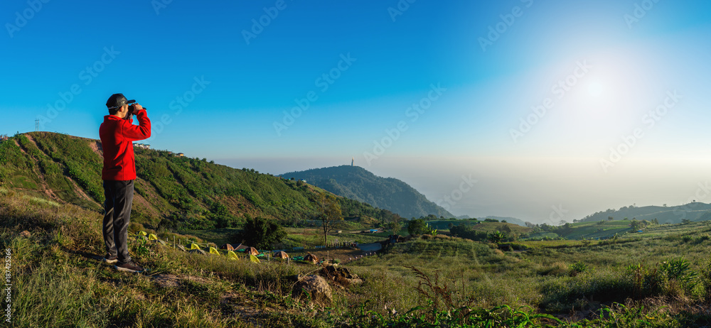 traveler looking in binoculars enjoying view above clouds traveler looking in binoculars enjoying view above clouds
