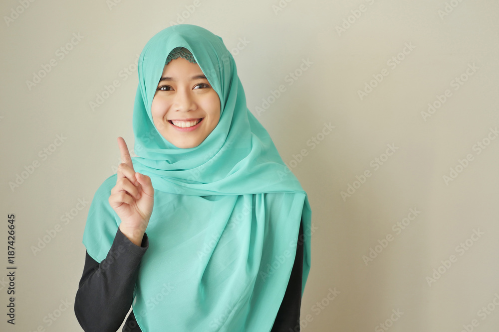 woman pointing number 1 up, asian muslim woman model woman pointing number 1 up, asian muslim woman model
