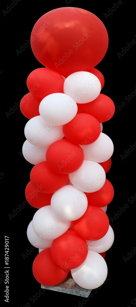 High vertical installation of red and white balloons on a granite stand ...