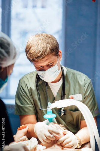 an experienced doctor makes anesthesia to a child