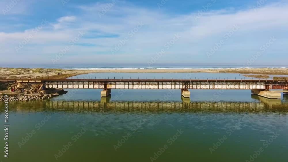 Train Bridge Crossing Seaside Pacific Lagoon - Aerial View Train Bridge Crossing Seaside Pacific Lagoon - Aerial View