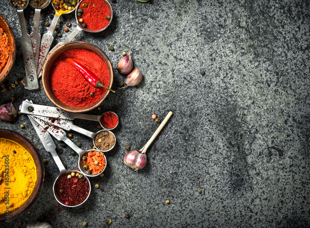 Various herbs and spices with measuring spoons. Various herbs and spices with measuring spoons.
