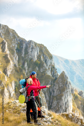 adventure  travel  tourism  hike and people concept - smiling couple walking with backpacks outdoors