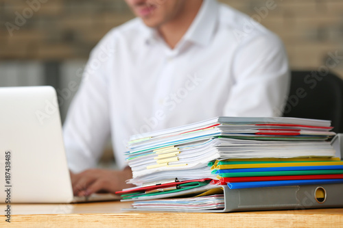 Stack of documents on offic...