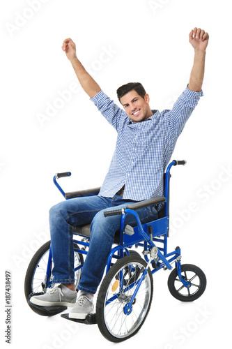 Attractive young man in wheelchair on white background